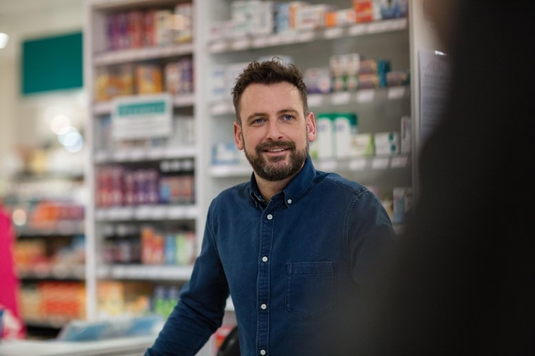 Reliance Pharmacist serving customer